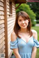 A woman in a blue dress posing for a picture.