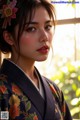 A woman in a kimono with a flower in her hair.